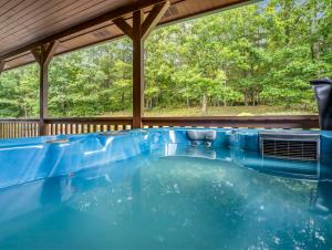 a swimming pool on a house with a deck at Hot Tub - Cabin Retreat -Firepit - Lake Lure - Chimney Rock in Union Mills