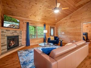 a living room with a couch and a fireplace at Hot Tub - Cabin Retreat -Firepit - Lake Lure - Chimney Rock in Union Mills