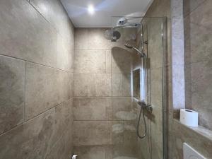 a bathroom with a shower with a glass door at Adonis Sanary Grand Hôtel des Bains in Sanary-sur-Mer +77 photos