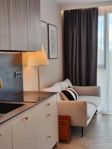 a living room with a couch and a table at EASY RENT Apartments - Unia Art Residence 127, Basen & SPA, Centrum 24h Check-in in Lublin