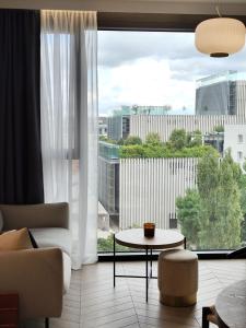 a living room with a table and a large window at EASY RENT Apartments - Unia Art Residence 127, Basen & SPA, Centrum 24h Check-in in Lublin
