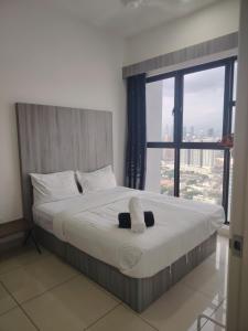 a bedroom with a large bed with a large window at Trion Residence Kuala Lumpur by Centrix in Kuala Lumpur