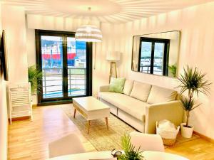 a living room with a couch and a table at The Cliffs - Sunset Village Beach 3C in Viveiro