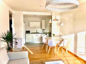 a kitchen and dining room with a table and chairs at The Cliffs - Sunset Village Beach 3C in Viveiro +22 photos