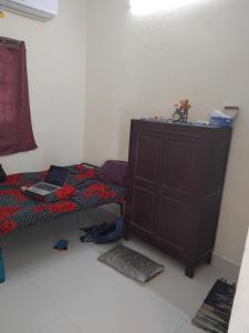 a bedroom with a bed with a laptop on it at Ramani's Stay in Chidambaram