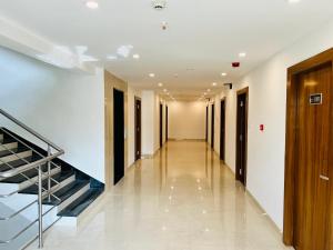 a hallway of a building with a staircase and halls at HOTEL SIGNATURE BANJARA HILLS Hyderabad in Hyderabad +63 photos