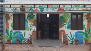a building with a mural of plants on it at bohom STAYORA in Nedumbassery