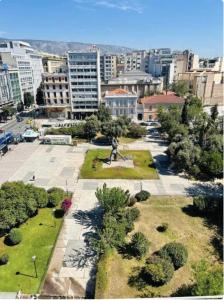 a park with a statue in the middle of a city at Family Luxury Suite by Zeus Suites in Athens +20 photos