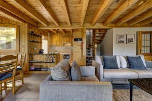 a living room with two couches and a kitchen at Chalet Colonia in La Tzoumaz +34 photos