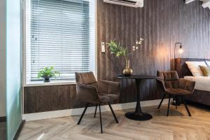 a bedroom with a table and two chairs and a bed at HotelBed w aircon at City Villa Tilburg Willem 1 in Tilburg