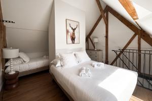a bedroom with a bed with a deer picture on the wall at La Louvière in Villard-de-Lans