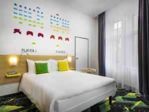 a hotel room with a bed and a window at Ibis Styles Budapest Center in Budapest +87 photos