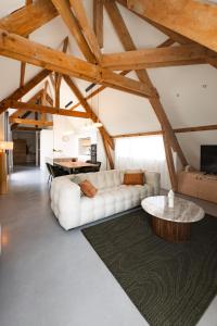 a living room with a white couch and a table at La Louvière in Villard-de-Lans