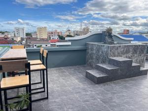 a patio with tables and chairs on a roof at Sherly 888 Hotel in Hua Hin