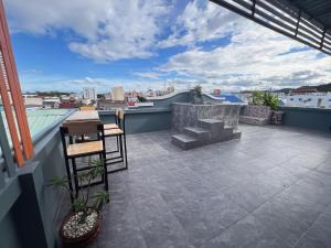 a balcony with a table and chairs on a roof at Sherly 888 Hotel in Hua Hin