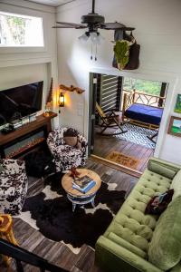 a living room with a couch and a table at Creekside Gem, Hot Tub, Sleeping Porch, Fire Pit in Mentone