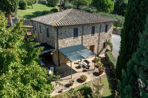 an aerial view of a stone house with a roof at Maria Gabriella Holiday Home In Monticchiello in Monticchiello +39 photos
