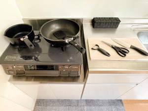 a kitchen stove with a pot on top of it at Asakusa 2DB Stuido Free Wi-Fi in Tokyo