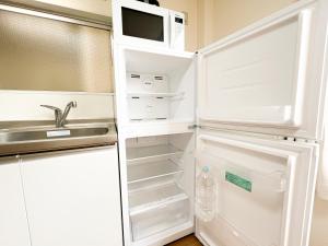 a white refrigerator with a microwave in it at Asakusa 2DB Stuido Free Wi-Fi in Tokyo +9 photos