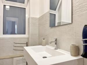 a bathroom with a white sink and a mirror at Palermo central stay in Palermo +258 photos