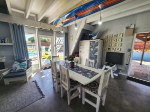 a dining room with a white table and chairs at Sedgefield Holiday Accommodation in Sedgefield