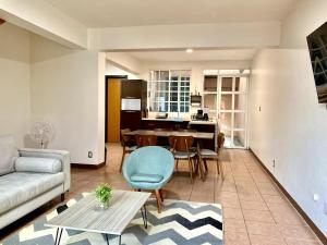 a living room with a couch and a table at Family Size - 4BR House in Oaxaca - Peaceful in Oaxaca City