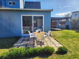a table and chairs in the backyard of a house at Sedgefield Holiday Accommodation in Sedgefield