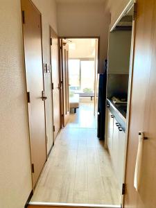 a hallway leading to a kitchen with a door open at 5Close to Nagoya Station, with amazing views in Nagoya