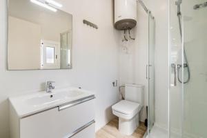 a bathroom with a toilet and a sink and a shower at AB Poble Sec - Plaza España in Barcelona