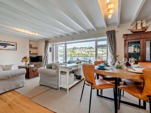 a living room with a table and a dining room at 2 Bed in Polruan PC074 in Fowey
