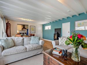a living room with a couch and a table at 2 Bed in Polruan PC074 in Fowey