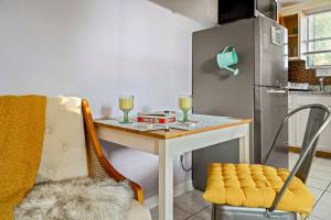 a small kitchen with a table with two glasses of wine at Salthaus West Palm Beach - NEW Saltwater Pool & Spa! in West Palm Beach