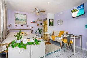 a bedroom with a bed and a table and a couch at Salthaus West Palm Beach - NEW Saltwater Pool & Spa! in West Palm Beach