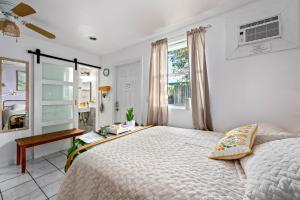 a bedroom with a large bed and a window at Salthaus West Palm Beach - NEW Saltwater Pool & Spa! in West Palm Beach +50 photos