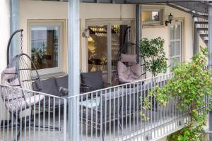 a porch with chairs and plants on it at Holiday&Stay Apartment Big Blue Beamer 10 Personen in Blaubeuren