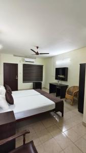 a bedroom with a large bed and a living room at UPPERCREST RESIDENCY PALA in Pala