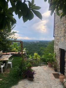 a patio with a table and chairs and a view at Ca' Parodi Bel View in Parodi Ligure