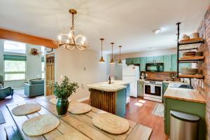a kitchen with green cabinets and a wooden table at Hot Tub and Deck Cabin Near Dtwn Alma and Breck in Alma