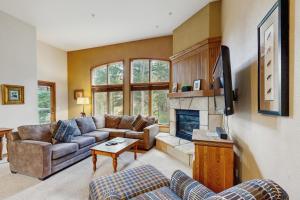 a living room with a couch and a fireplace at Riverbend Lodge #001 in Breckenridge