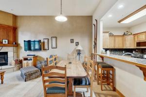 a kitchen and living room with a table and chairs at Riverbend Lodge #001 in Breckenridge