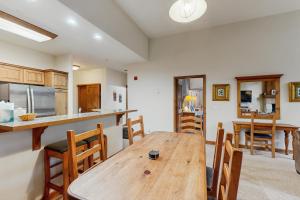 a kitchen and dining room with a wooden table and chairs at Riverbend Lodge #001 in Breckenridge
