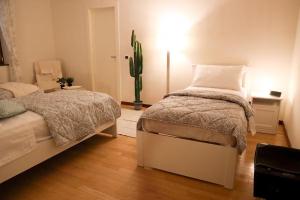 a bedroom with two beds and a cactus at Country House, on the slopes of Vesuvius 3 in Terzigno