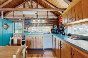 a kitchen with wooden cabinets and a blue counter top at Rockwood Cabin on Moosehead Lake in Rockwood