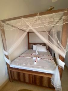 Postel nebo postele na pokoji v ubytování Baobab Lagoon