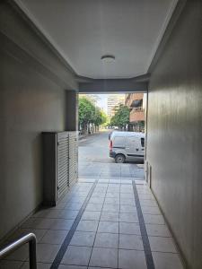 a hallway with a door to a street with a van at Monteagudo 747 in San Miguel de Tucumán +15 photos