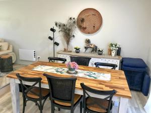 a dining room with a wooden table and chairs at Spacious Family Retreat on the edge of Tenterfield in Tenterfield