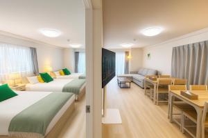 a hotel room with two beds and a living room at TOEI BUSSAN Building20 in Osaka