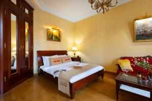 a bedroom with a large bed and a couch at Apartment KeyGo #0035 is the key to the center of Yerevan in Yerevan