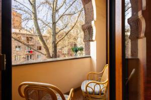 a window with chairs and a view of a city at Apartment KeyGo #0035 is the key to the center of Yerevan in Yerevan