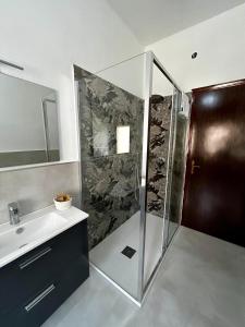 a bathroom with a shower and a sink at Da zio Emilio in Cardedu